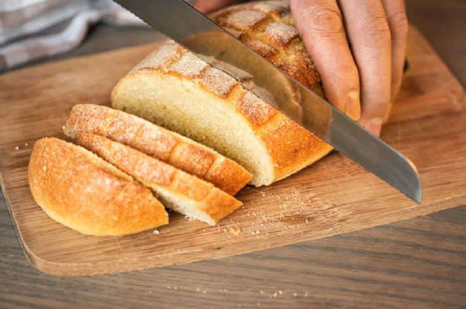 Serrated knife cutting bread 