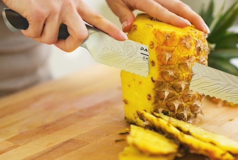 serrated knife cutting Pineapple