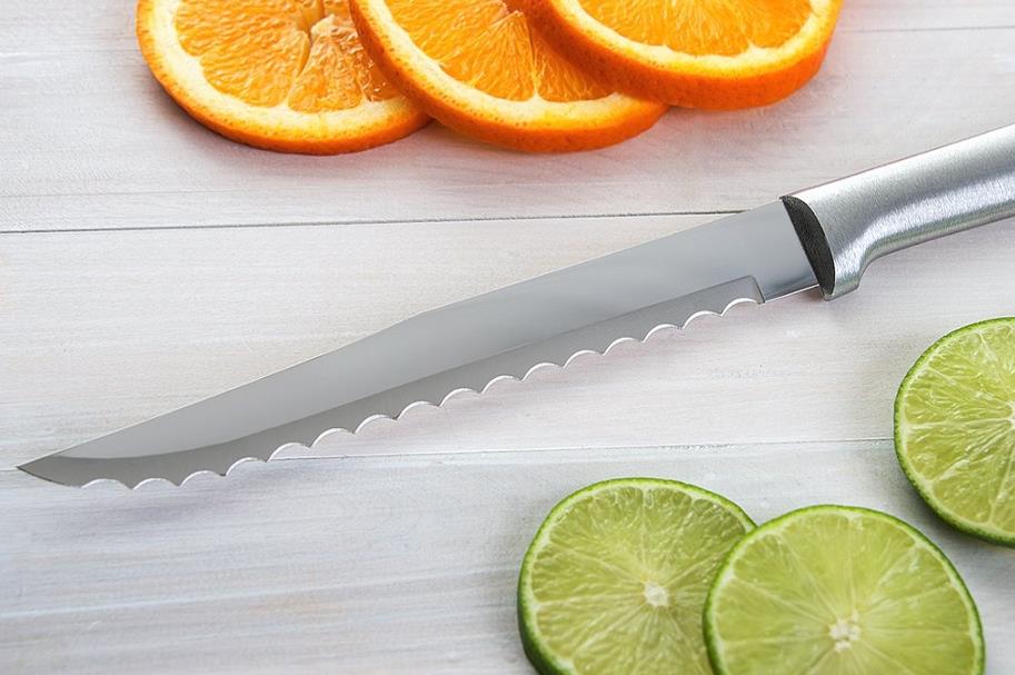 serrated knife cutting citrus fruits