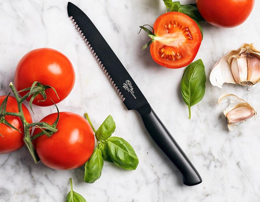 serrated knife cutting tomatoes 