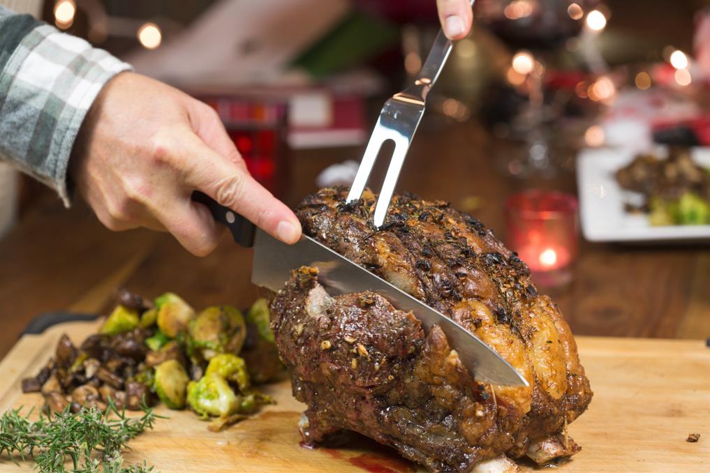 Carving a cooked prime rib