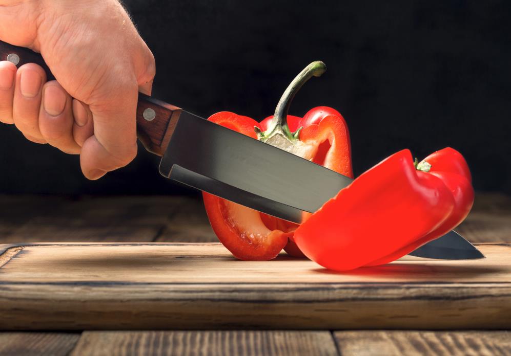 Chef knife cutting tomato 