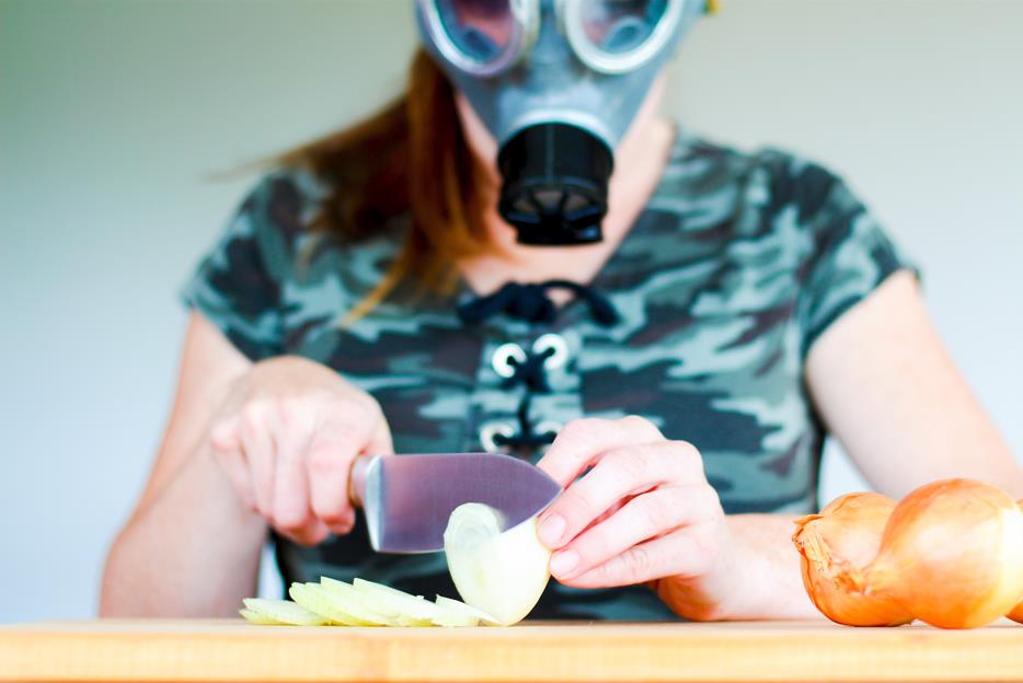 Cutting an onion with eye goggle