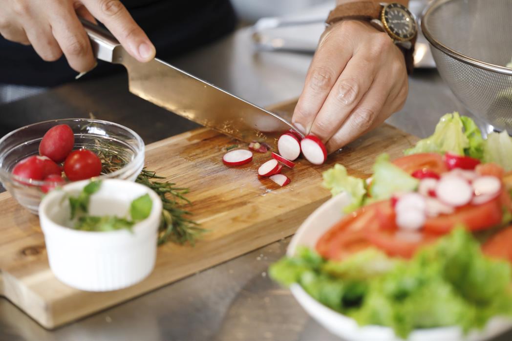 Men cutting vegetables 