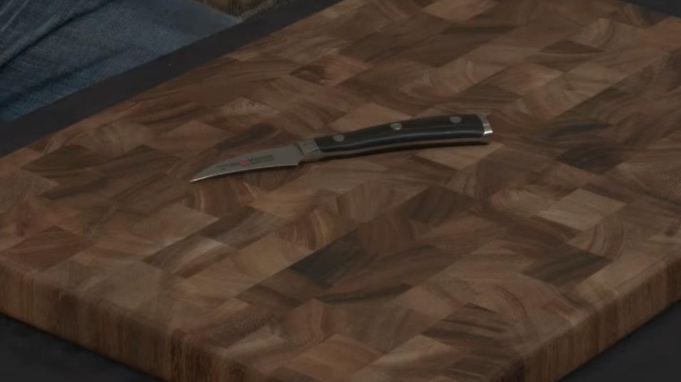 tourné knife on wooden board