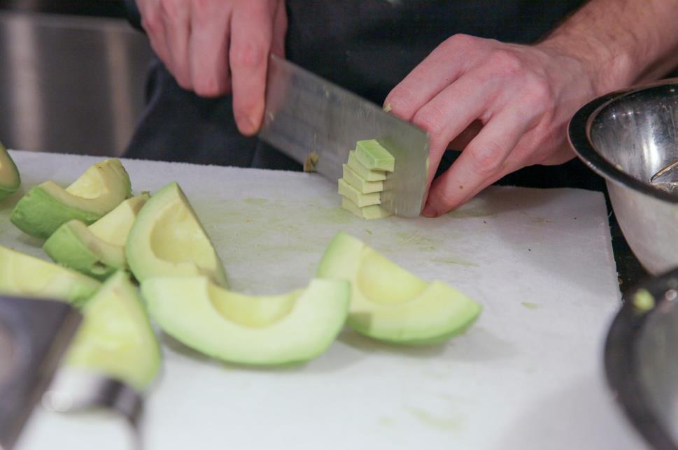 Chinese cleaver cutting avocado