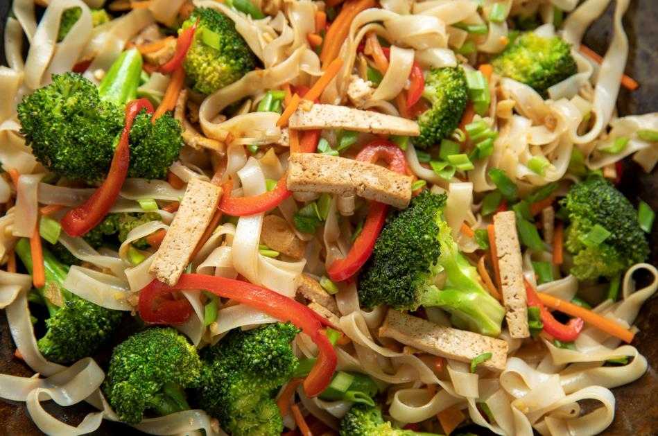 Close-up view of stir-fried noodle salad dish with broccoli and tofu