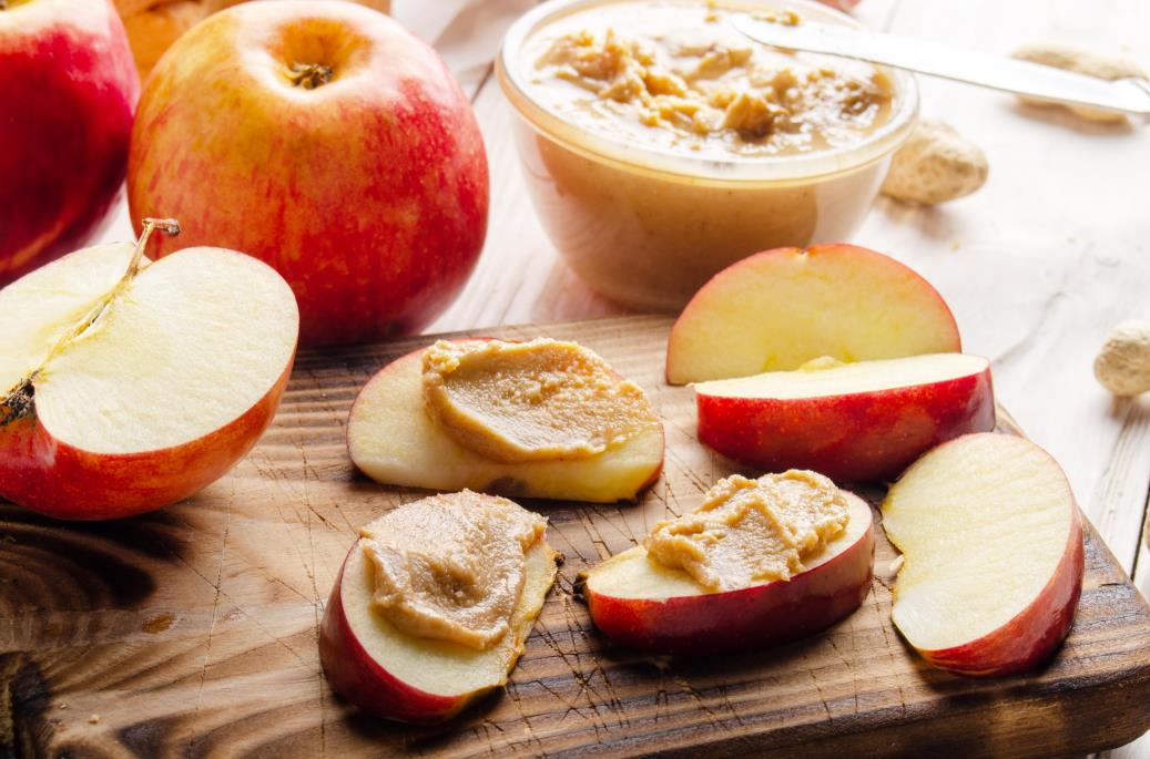 Cut apples placed on top of wooden cutting board