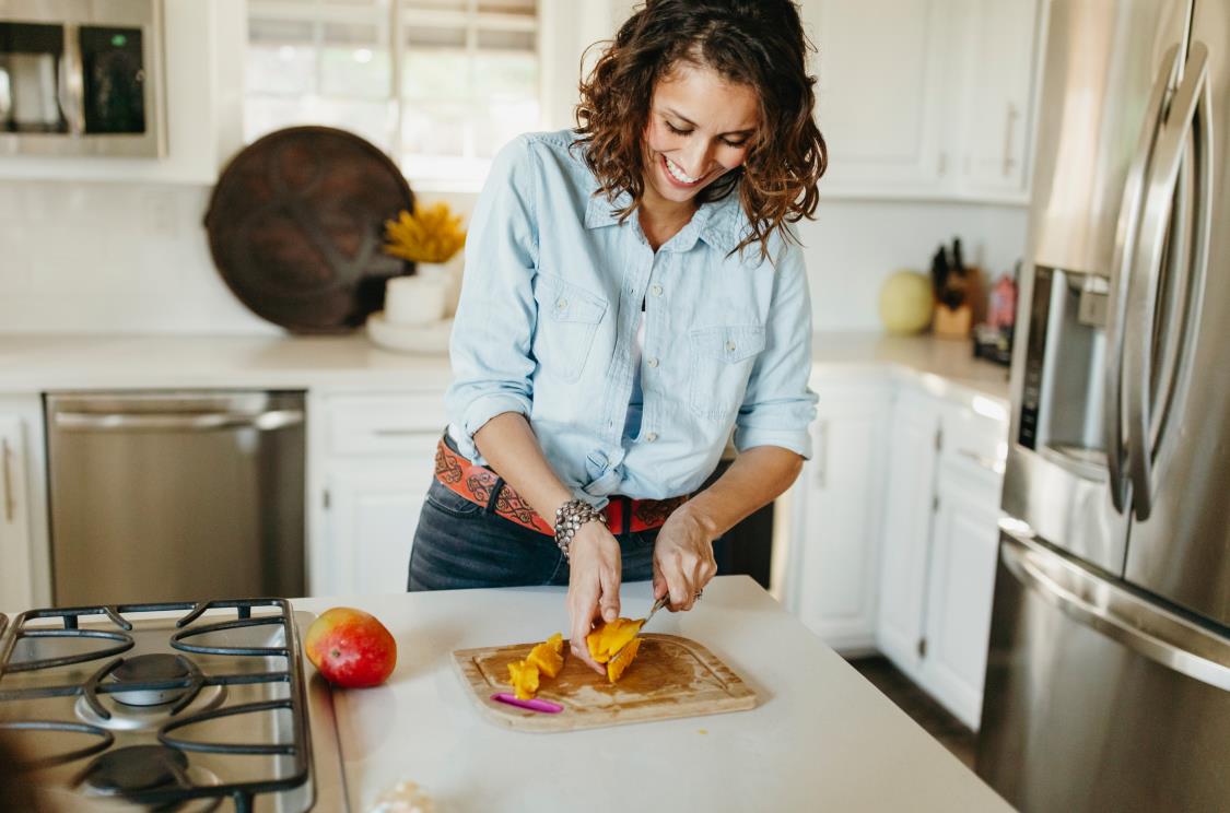 women cutting mango in the kitchen