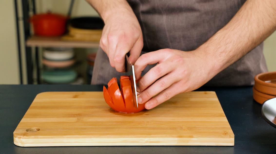 Step 3. Rotate the tomato 90 degrees and make additional lengthwise cuts