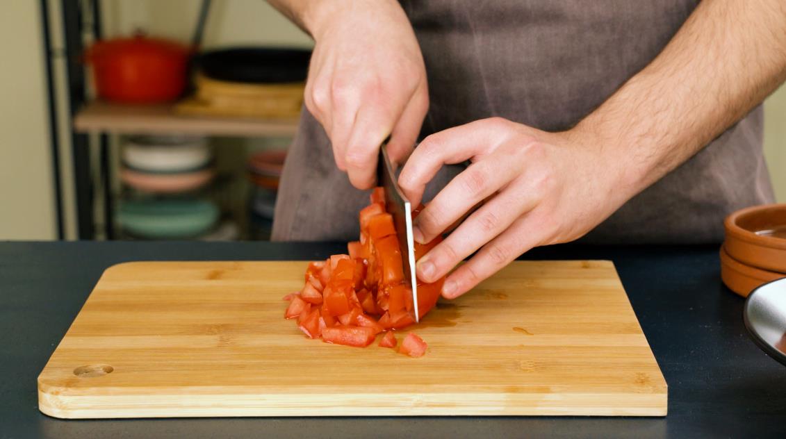 Step 4. Finally, turn the tomato on its side and cut it into uniformly cubes. 