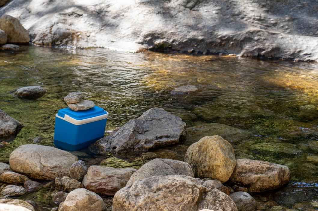 Cooler sitting inside of the river