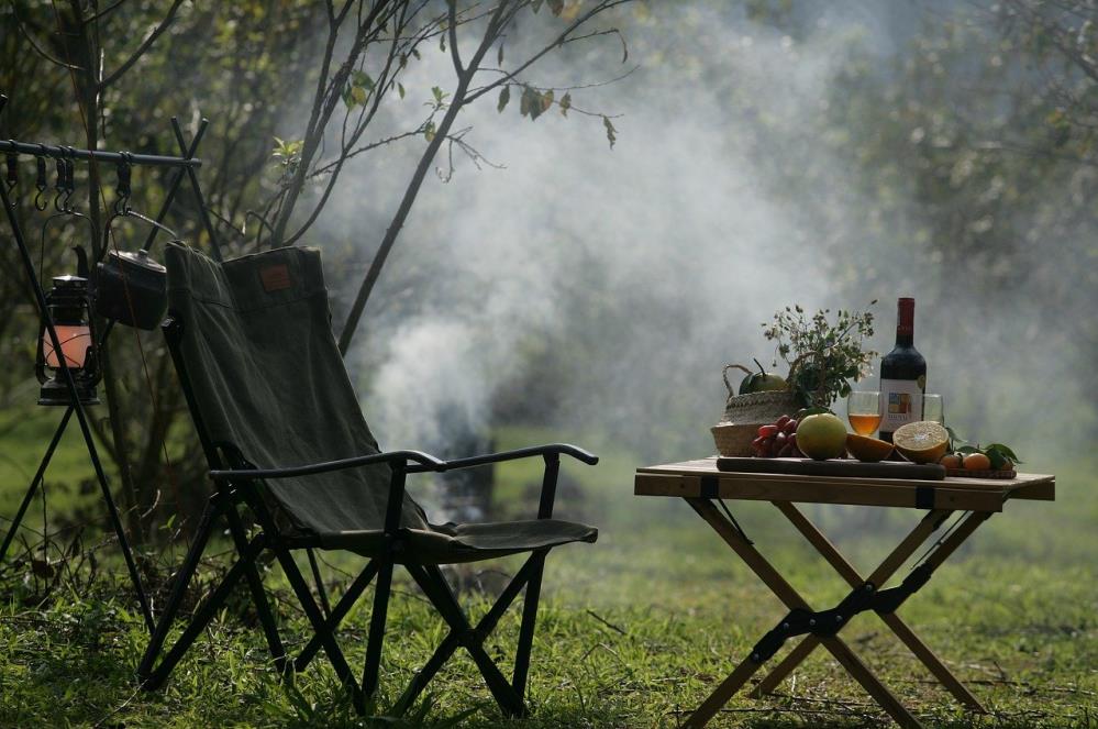 camping chair, lantern, table and food