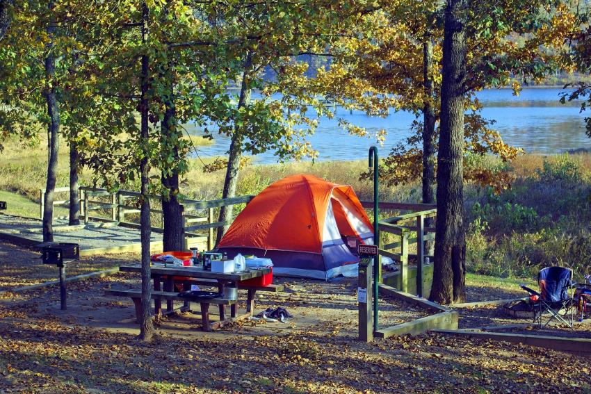 orange tent setting up in the wild