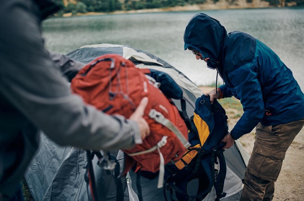 two backpackers setting up tent