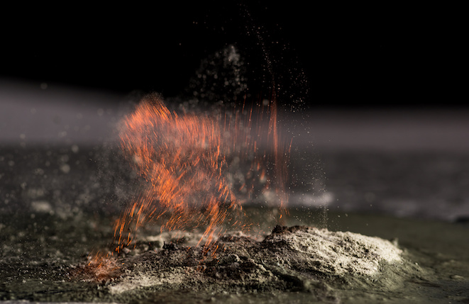 burning sand and a splash of water on a black background