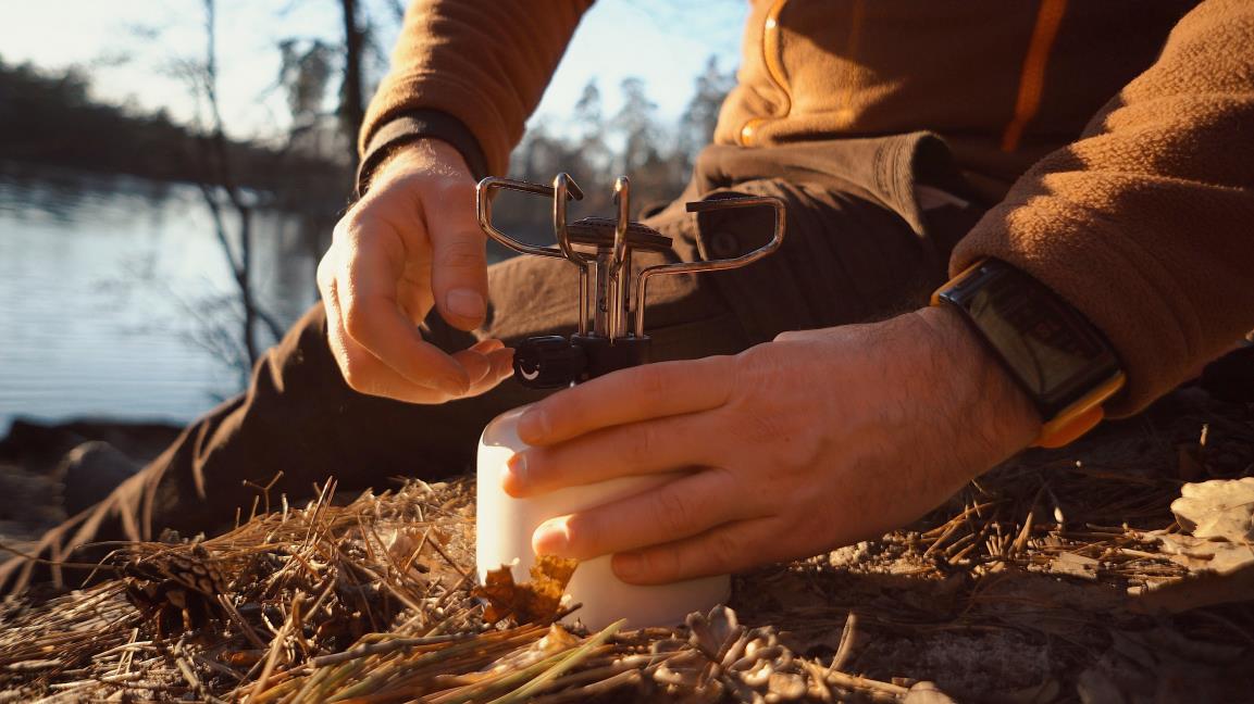 setting up camping stove to boil water