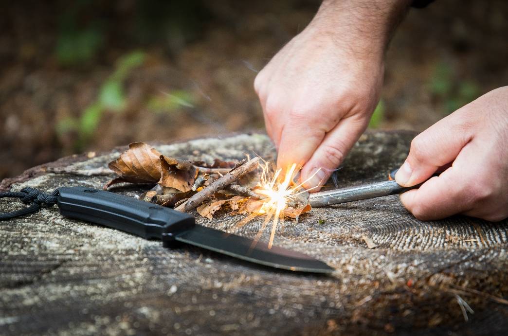 survivalist camper making fire bushcraft