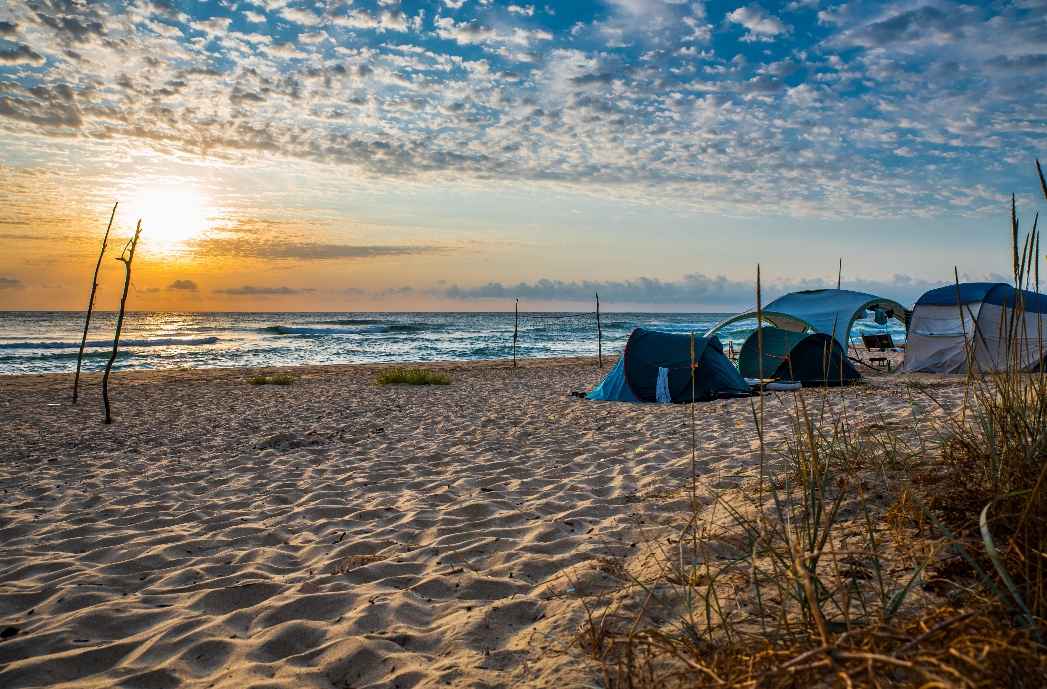 tent camping on the beach sunset view